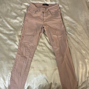 Pale pink skinny jeans